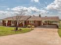 Traditional brick home with attached carport and lush lawn at 114 Joe Teague Rd, Hickory, NC 28601