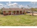 Charming brick home featuring a covered porch and well-maintained front yard at 114 Joe Teague Rd, Hickory, NC 28601
