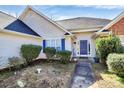 Home exterior featuring a blue door and shutters and manicured landscaping at 1229 Kent Dr, Lancaster, SC 29720