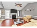 View of the living room offering a ceiling fan and fireplace with a mounted television above at 1229 Kent Dr, Lancaster, SC 29720