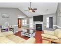 Living room with vaulted ceilings, fireplace, fan and wood floors at 1229 Kent Dr, Lancaster, SC 29720