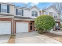Charming townhouse with brick and siding, featuring an attached garage and landscaped front at 130 Clydesdale Ct, Matthews, NC 28104
