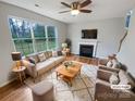 Bright living room featuring a cozy fireplace, large windows, and stylish furnishings at 1400 Wessex Ct, Monroe, NC 28110