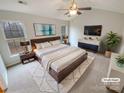 Spacious main bedroom with a king bed, ceiling fan, and ample natural light at 1400 Wessex Ct, Monroe, NC 28110