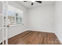 Bright bedroom with hardwood floors and a large window at 146 Dogwood Grove Pl, Troutman, NC 28166