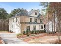 Spacious two-story home featuring a brick and siding exterior with a wide driveway and two-car garage at 147 Belfry Loop, Mooresville, NC 28117