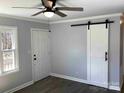 Living area with modern ceiling fan, stylish barn door and durable flooring at 177 Valleydale Dr, Gastonia, NC 28056