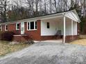 Brick home with carport and gravel driveway, offering convenience and ample parking space at 177 Valleydale Dr, Gastonia, NC 28056