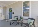 Inviting front porch with cozy seating, a wreath on the door, and a view of the neighborhood at 2212 Yadkin Ave, Charlotte, NC 28205