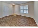 Bright living room with beautiful wood flooring, a large window and multiple entry doors at 242 Elrosa Rd, Mooresville, NC 28115