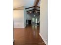 Open living room boasting vaulted ceilings, wooden beams, and a cozy fireplace feature at 2608 Glyncastle Way, Gastonia, NC 28056