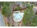 Aerial view of community pool surrounded by a sun deck and mature trees at 303 Ridge Reserve Dr # 29, Clover, SC 29710