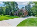 Spacious home with a long driveway, lush green lawn, and mature trees offering plenty of shade at 303 Ridge Reserve Dr # 29, Clover, SC 29710