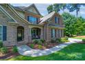 Charming front entrance with stone accents, a cozy porch, and meticulously maintained landscaping at 303 Ridge Reserve Dr # 29, Clover, SC 29710