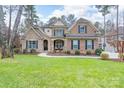 Charming two-story home with a brick facade, classic shutters, and an inviting front porch at 303 Ridge Reserve Dr # 29, Clover, SC 29710