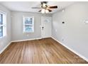 Bright living room with hardwood floors, a ceiling fan, and ample natural light from a window at 325 Oregon St, Charlotte, NC 28208