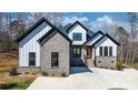 Eye-catching new construction featuring gray brick, white siding, a concrete driveway, and a welcoming front entrance at 4060 Steve Ikerd Ne Dr, Hickory, NC 28601
