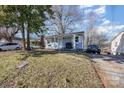 Quaint home with light blue siding, a cozy front porch, and well-maintained landscaping at 421 N Tradd St, Statesville, NC 28677