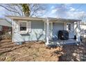 Charming single-story home featuring light blue siding and a cozy front porch area at 421 N Tradd St, Statesville, NC 28677