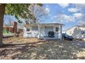 Quaint home with light blue siding, a cozy front porch, and well-maintained landscaping at 421 N Tradd St, Statesville, NC 28677