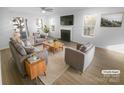 Bright living room featuring a fireplace, large windows, and modern furniture at 4219 Robinwood Dr, Charlotte, NC 28212
