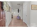 Bright foyer showcases wood flooring, fresh white walls, and a view into the adjacent living room at 4720 Maiden Creek Way, Maiden, NC 28650
