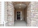 Covered front entrance features stone pillars, a decorated front door, and a welcoming atmosphere at 4720 Maiden Creek Way, Maiden, NC 28650