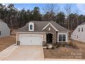 Inviting single-Gathering home showcases stone detailing, a two-car garage, and well-maintained landscaping at 4720 Maiden Creek Way, Maiden, NC 28650