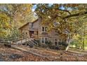 View of the rustic home showcasing its wood exterior and cozy porch at 5084 Mariana Ct, Tega Cay, SC 29708