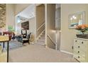 Bright living room featuring stairs, neutral carpet, and a glimpse of cozy furnishings at 5084 Mariana Ct, Tega Cay, SC 29708