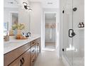 Modern bathroom with double vanity, a walk-in shower, and neutral tones at 5723 Castlerea Dr, Charlotte, NC 28217