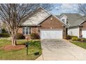 Charming brick home featuring a well-manicured lawn and a convenient two-car garage at 620 Amethyst Cir, Fort Mill, SC 29708