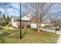 Traditional home showcasing brick accents, a two-car garage, and a beautifully landscaped front yard at 620 Amethyst Cir, Fort Mill, SC 29708