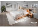 Serene main bedroom featuring a plush bed, tasteful decor, and plenty of natural light at 6318 Pink Dogwood Ln, Charlotte, NC 28262