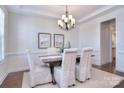 Elegant dining room with a chandelier, decorative wainscoting, and seating for six at 6521 Shoff Cir, Charlotte, NC 28215