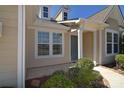 Inviting home entrance featuring a covered porch, well-maintained landscaping, and natural light at 6521 Shoff Cir, Charlotte, NC 28215