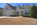 Charming single-Gathering home featuring a two-car garage, dormer windows, and a well-manicured lawn at 6521 Shoff Cir, Charlotte, NC 28215