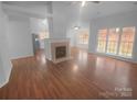 Open-concept living space with a cozy fireplace and gleaming hardwood floors at 6809 Brancusi Ct, Charlotte, NC 28215