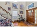 Inviting foyer with hardwood floors, staircase, and natural light at 732 Ellsworth Rd, Charlotte, NC 28211