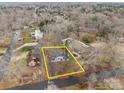 Aerial view of property showcasing the house and surrounding neighborhood with mature trees at 805 East St, Albemarle, NC 28001