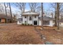 Inviting two-story home with a crisp white facade, front door, and stone walkway at 805 East St, Albemarle, NC 28001