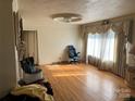 Bright living room with hardwood floors, classic details, and lots of natural light from large windows at 816 Horah W St, Salisbury, NC 28144