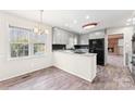 Traditional kitchen with gray cabinets, wood flooring, and backyard views at 822 Bethlehem Rd, Kings Mountain, NC 28086