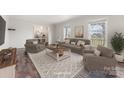 Bright living room with large windows, comfortable seating, and stylish area rug for a cozy atmosphere at 822 Bethlehem Rd, Kings Mountain, NC 28086