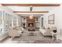 Inviting living room features a brick fireplace, built-in shelves, and exposed wood beams creating a warm ambiance at 822 Bethlehem Rd, Kings Mountain, NC 28086