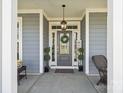 Close-up of the front door with decorative wreath and sidelights at 8638 Raven Top Dr, Mint Hill, NC 28227