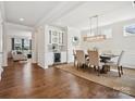 Bright dining room with a modern light fixture, elegant decor, and seamless access to the living area at 924 Stebbins Dr, Fort Mill, SC 29715
