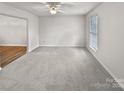 Bright, open living room with neutral walls, plush carpeting, and lots of natural light at 10301 Shelter Rock Ct, Charlotte, NC 28214