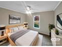 Cozy bedroom featuring a ceiling fan, neutral color palette, and large window with natural light at 106 Cape Breton Trl, Gastonia, NC 28056