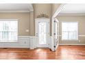 Bright foyer with hardwood floors and a beautifully detailed front door for natural light at 10615 Persimmon Creek Dr, Mint Hill, NC 28227